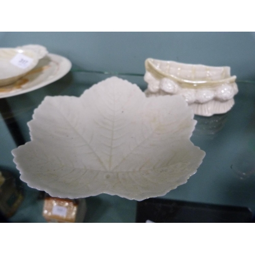 317 - Five pieces of Belleek porcelain to include a leaf-shaped dish, boat ornament, butter dish (black st... 