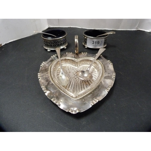 319 - Pair of silver salts with blue glass liners, silver plated salt spoons, and an EP heart-shaped butte... 