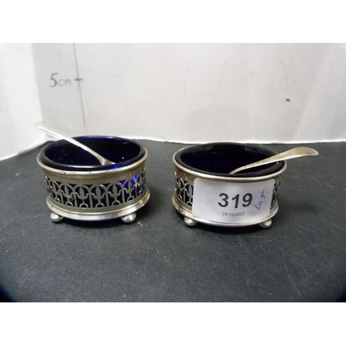 319 - Pair of silver salts with blue glass liners, silver plated salt spoons, and an EP heart-shaped butte... 