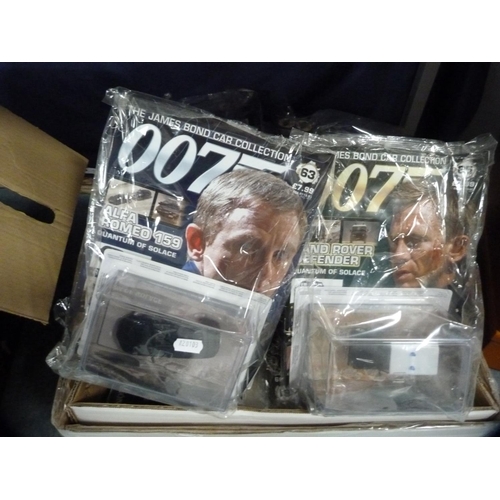 334 - The James Bond Car Collection magazines and vehicles.