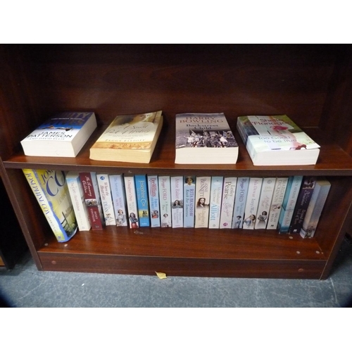 423 - Modern open bookcase containing assorted novels.