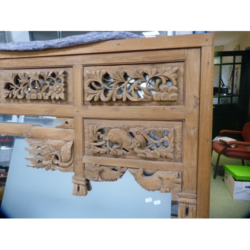 479 - Large Indonesian style wood-framed mirror with carved top.