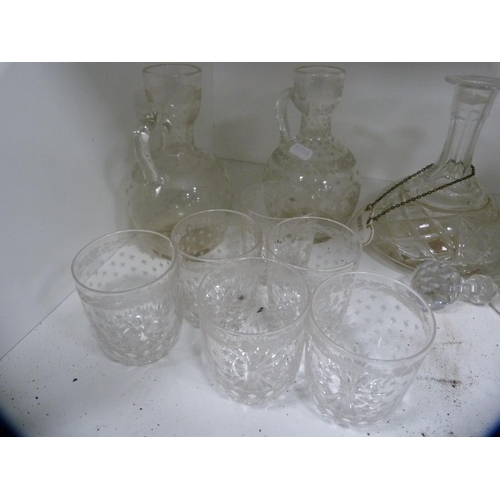 94 - Collection of glass decanters, set of six tumblers, two claret jugs etc (one shelf).