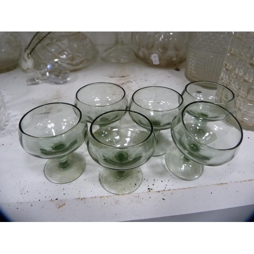 94 - Collection of glass decanters, set of six tumblers, two claret jugs etc (one shelf).