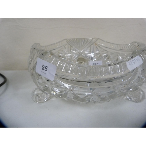 95 - Heavy cut glass fruit bowl on three scroll supports and a boat-shaped bowl.  (2)