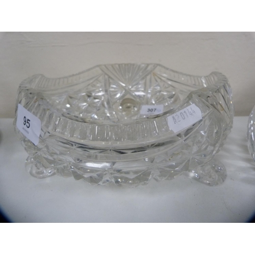 95 - Heavy cut glass fruit bowl on three scroll supports and a boat-shaped bowl.  (2)