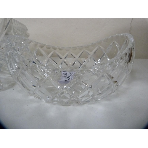 95 - Heavy cut glass fruit bowl on three scroll supports and a boat-shaped bowl.  (2)