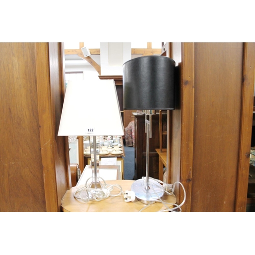 122 - Chrome two branch table lamp with black oval shade, and a geometric design table lamp with shade.