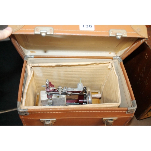 156 - Cased miniature sewing machine.