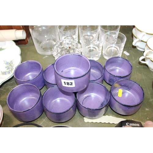 182 - Nine purple ground pottery bowls.