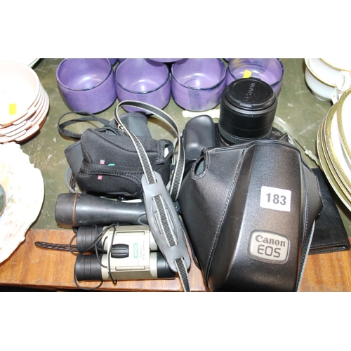 183 - Canon 750 camera, a lens, a pair of field binoculars, a torch, and other accessories.