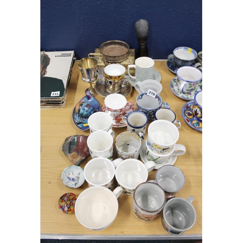 216 - Ceramics to include Highland Stoneware, mugs, a wine coaster, an African bust, etc.