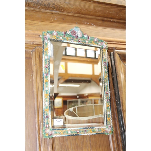 560 - Floral encrusted bevel-edge wall mirror.