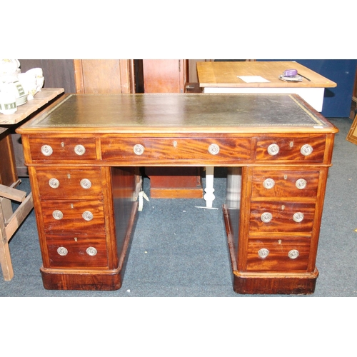 567 - Mahogany pedestal knee-hole desk, with nine frieze drawers and green leather skiver.