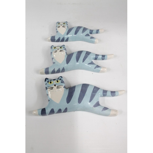 64 - Three Katz & Co. style flying/leaping cat plaques.