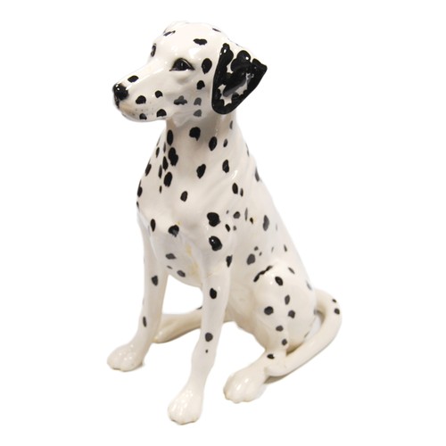 Beswick model of a Dalmatian and three pottery cats.  (4)