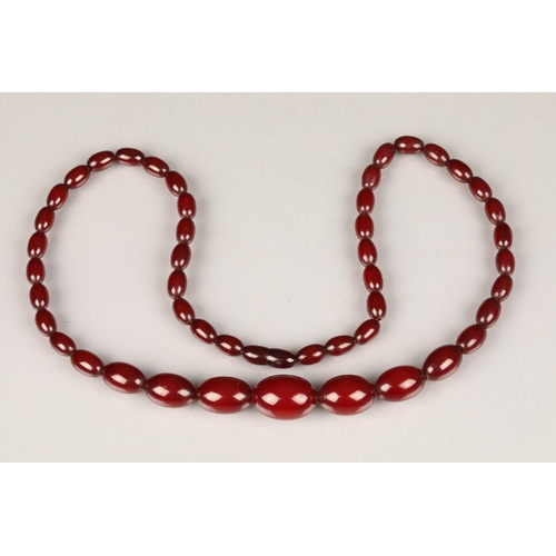 112 - Cherry amber bead necklace, length 67cm, largest bead 25mm, total weight 44g