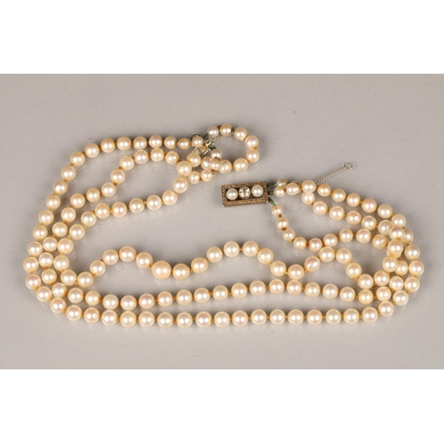 116 - Ladies double strand pearl necklace, with white metal diamond set clasp, 0.33 carats