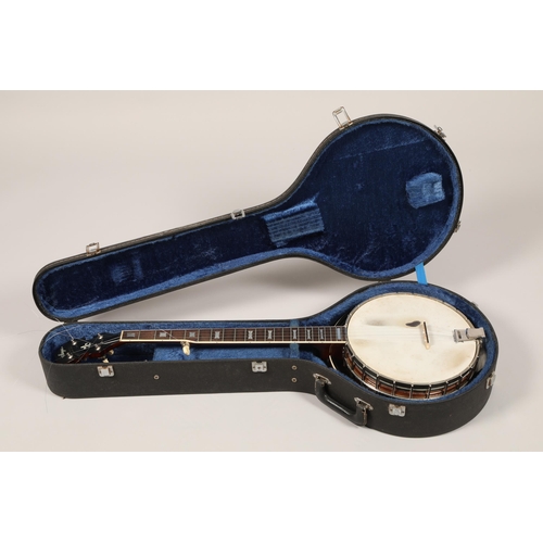 264 - A Saga 5 string Banjo, with Saga in mother of pearl on headstock, overall length 97 cm in lined and ... 