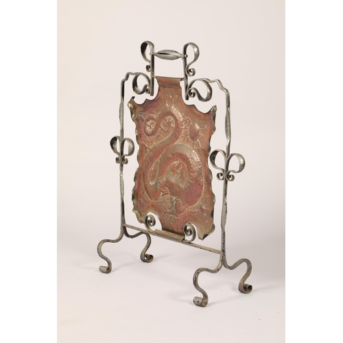 454 - Arts and crafts copper and wrought iron fire screen, with embossed coiled dragon decoration, 82cm hi... 