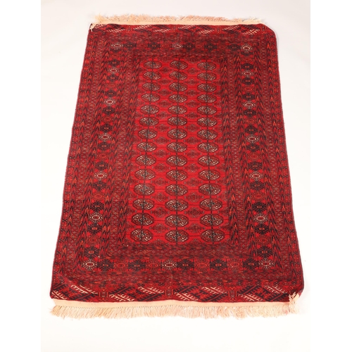 467 - Persian rug, red ground with blue and cream geometric lozenges, length 172cm, width 122cm