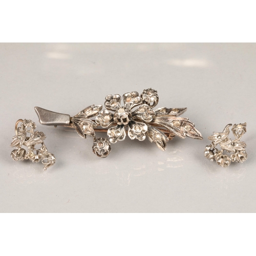 64 - 19th century unmarked white metal and diamond brooch, floral form with a matching pair of earrings, ... 