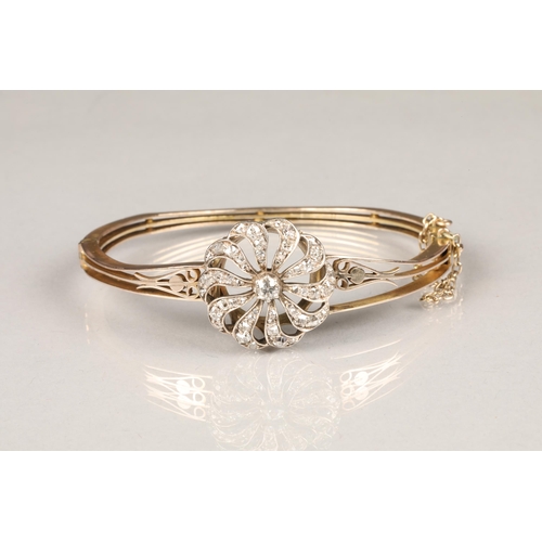 74 - Diamond set bangle, pierced unmarked stiff bangle, with a circular diamond encrusted mount, centre 0... 