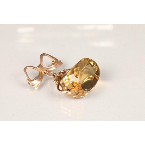 83 - 9 carat gold mounted citrine fob pendant, with a bow clasp