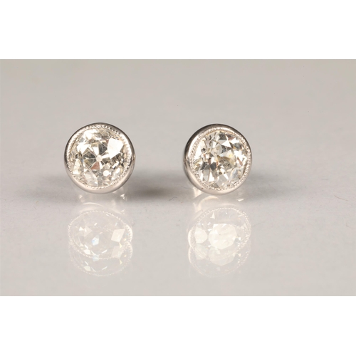 84 - Pair of diamond stud earrings, each set with a 1 carat old cut diamond