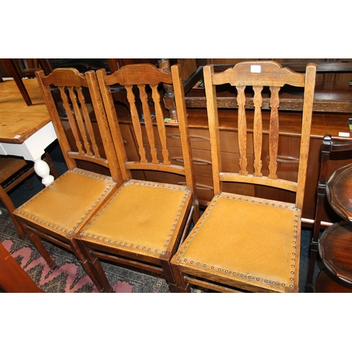 599 - Set of four oak splat back dining chairs.