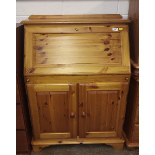 638 - Pine fall front writing bureau; raised on two cupboard doors