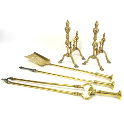 Set of three brass fire irons, comprising shovel, tongs and poker with flattened knop handles, each approx. 65cm long and a pair of fire dogs with moulded dolphin pad feet and foliate moulded knops and spindles, each 32cm high.  (5).