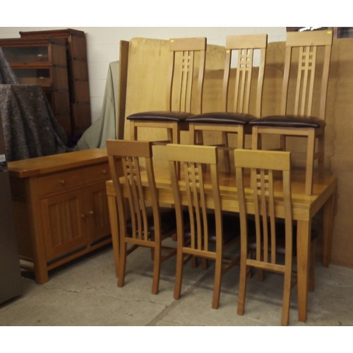 647 - Oak dining suite comprising draw leaf table; six single chairs and a sideboard