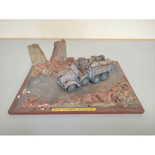 47 - Four collector's model military vehicles. To include  a German 88mm Flak 36 On Trolley, M1A1-HA... 