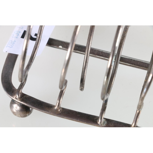 102 - Sterling silver six slice toast rack, on ball supports, maker JH, Edinburgh, 1841, 195g.