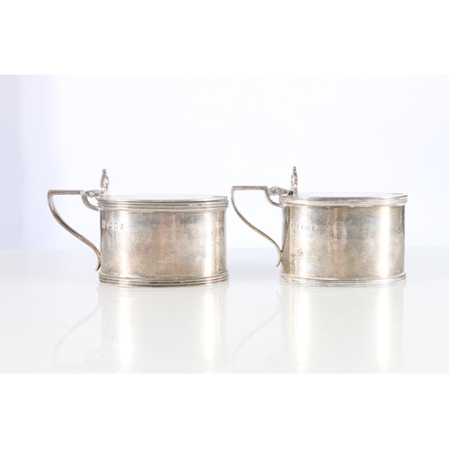 104 - Pair of sterling silver mustard pots, one with blue glass liner, Tessiers Ltd, London, 1963, 245g.