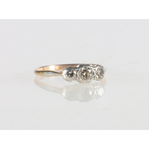 110 - Yellow gold and platinum (unhallmarked) three stone diamond ring, size M, 1.7g, in antique box.