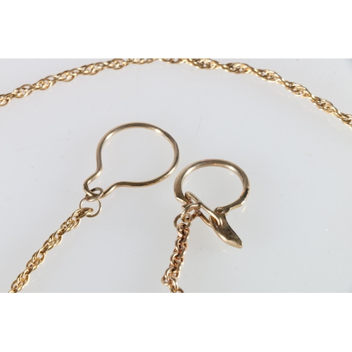 118 - 9ct gold clip, with yellow metal chain.