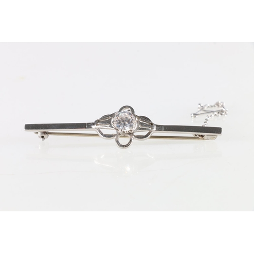 150A - 15ct white gold bar brooch set with faceted clear stone, 6.9g.