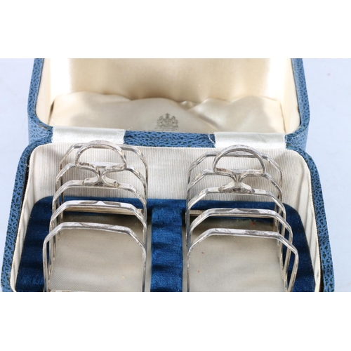 173 - Cased pair of sterling silver five bar toast racks, Edward & Sons, Birmingham, 1938, 91g.