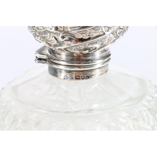 175 - Three heavily cut crystal silver topped toilet bottles. the silver tops heavily embossed, tallest 15... 