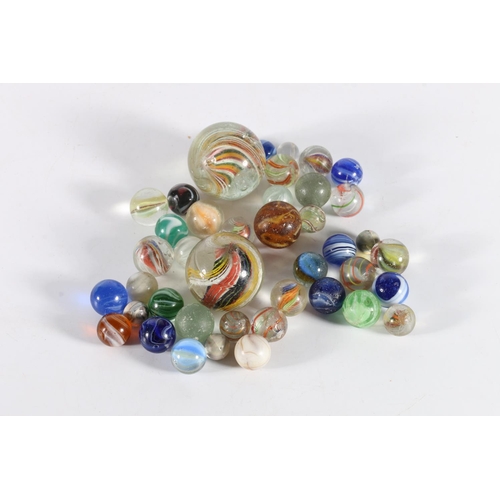 215 - Collection of antique hand blown glass marbles with swirl inclusions, the largest 4cm diameter, and ... 