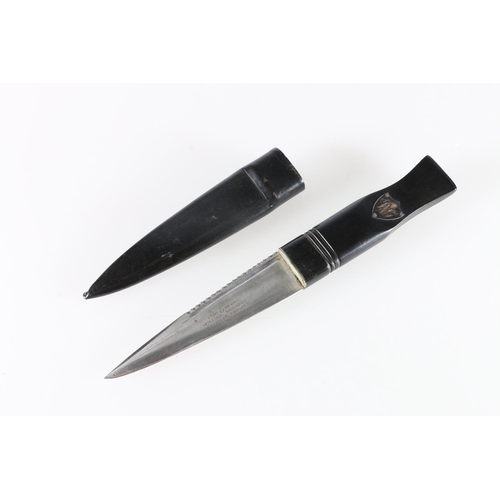 246 - Scottish sgian dubh of typical design with carved black horn handle bearing a shield with the initia... 