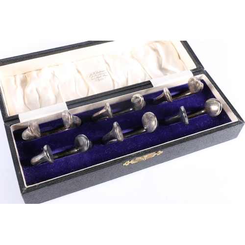 248 - Unusual set of six white metal napkin rings of torque form in fitted box retailed by Anderson of Elg... 