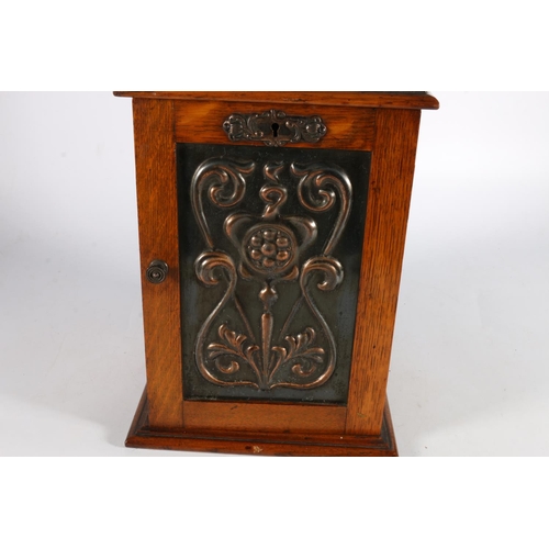 290 - Antique oak smokers' cabinet, the door inset with an Art Nouveau copper panel, 28cm tall.