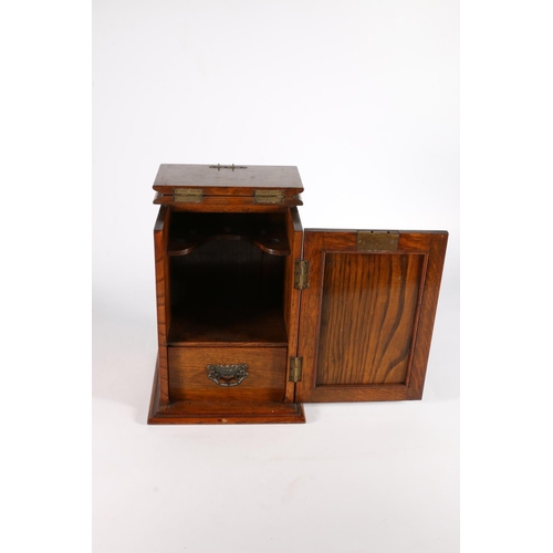 290 - Antique oak smokers' cabinet, the door inset with an Art Nouveau copper panel, 28cm tall.