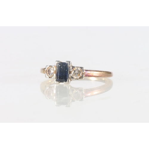 67 - 18ct gold and platinum ring set with diamond and central baguette cut sapphire, size L, 3.3g.