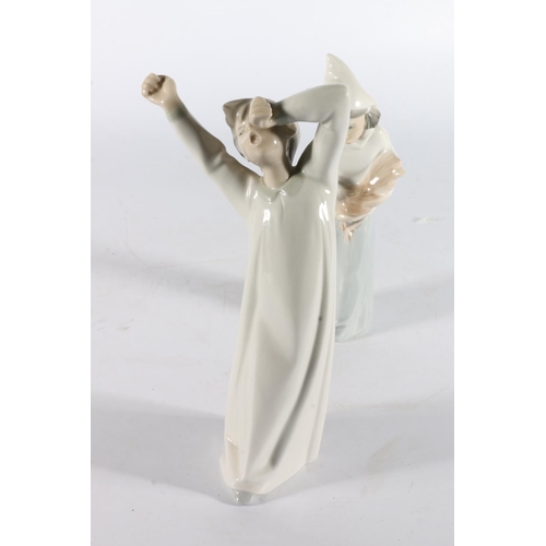 319 - Two Lladro of Spain porcelain figurines, one modelled as a girl with cockerel, the other a boy in ni... 