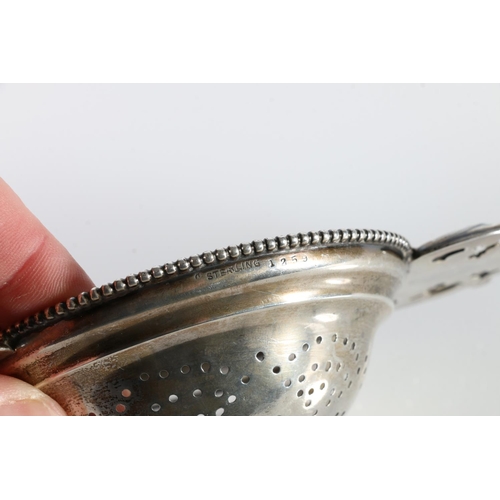 333 - Sterling silver tea strainer, stamped '1259', no makers marks, 79g gross, 19cm across the handles.