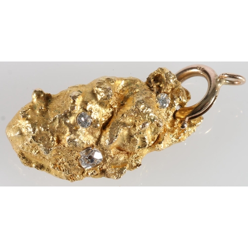 336 - Naturalist 'nugget' of gold set with three diamonds formed as a pendant, 3.1cm long, 22g gross.